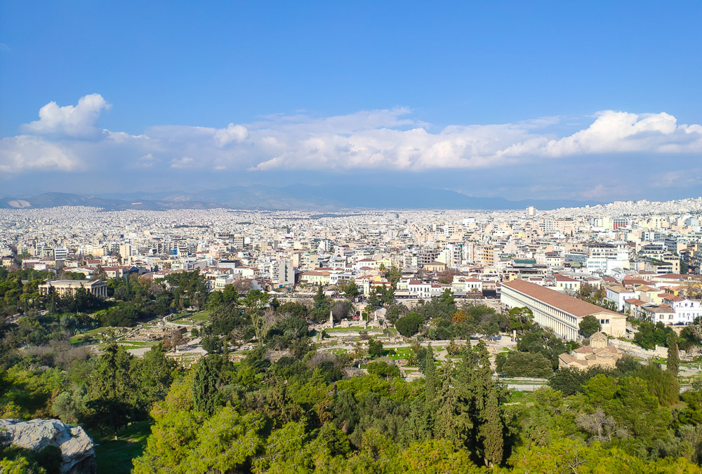 An overview of the Ancient Agora site just below the Areopagus Hill on a clear winter day.  The built up area of the city stretches from behind it far towards the horizon.